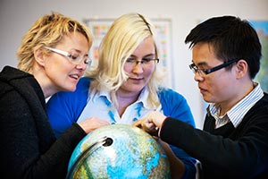 Maarit Ojala, tf. invandrarkoordinator, t.v. och Carita Latikka, tf. nringsombudsman, kollar var deltidsanstllda tolken Trung Tran har sina rtter. Tran har studerat flera r i Finland. Foto. ESA MELAMETS